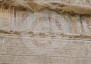 Hieroglyphic carvings on an ancient egyptian temple wall