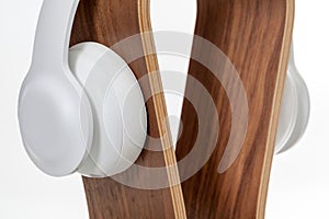 HIFI headphones High Fidelity on a wooden omega stand.  on white background