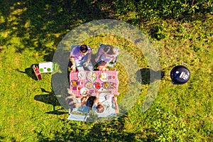 High above angle view friends spending free time cooking barbeque outside drinking beer having conversation