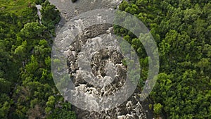 High above Drone aerial view on beautiful river with rapids and waterfalls. Extreme Rafting concept. Group of people on
