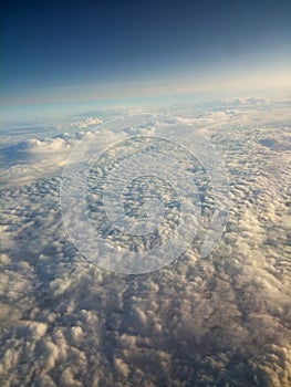 high above white fluffy clouds blue sky