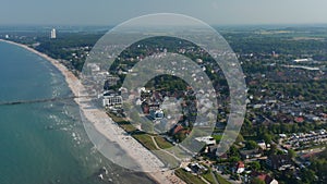 High aerial drone view of sensational summertime tourist beach in Scharbeutz, Germany, dolly in, sunny windy day