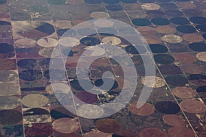 High aerial view of the crop circles created in farm fields by center pivot sprinklers