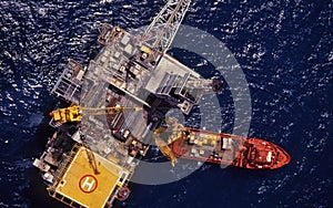 High aerial view down on the Mackerel platform with a drilling rig on deck and a workboat alongside