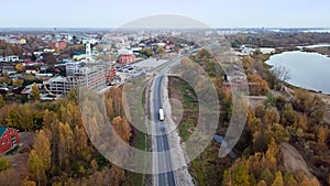 High aerial view of truck with cargo trailer driving into a small town
