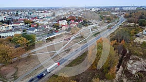 High aerial view of truck with cargo trailer driving through a small town