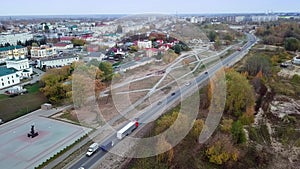 High aerial view of truck with cargo trailer driving through a small town