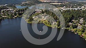 High aerial water users and waterfront homes overlooking Langford lake and distant development in Victoria BC Canada. u