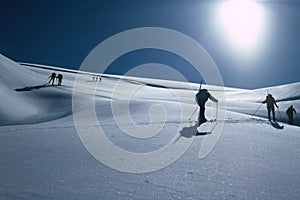 High alpine skiers on the way to the summit in winter Bernese Oberland in Switzerland