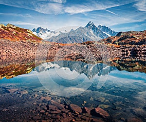 High Alps mountain feflected in cflm water of Chesery lake/Lac De Chesery, Chamonix location. Nice outdoor scene of Vallon de Bera