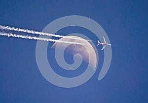 High Altitude Commercial Airliner Passing a Crescent Moon