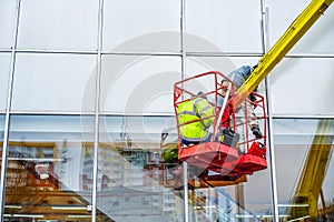 High-altitude installation works.  Professional installation work on a telescopic boom lift platform.