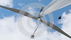 High-altitude installers with equipment serve wind generator