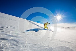 High altitude mountain explorer walking through deep snow photo
