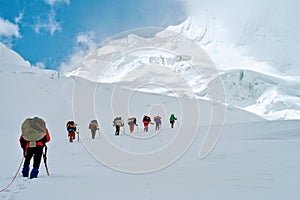 High Altitude Porters aproaching the highest trekking pass Verjerav that connects Shimshal valley with Snow Lake