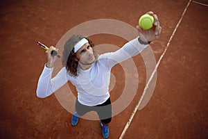 High angel view on man tennis player serving ball