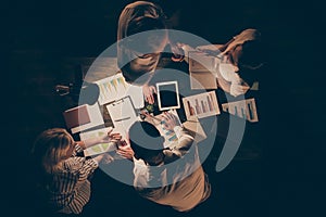 High angle above view photo of four busy hard-working business men women working overtime late evening dark office