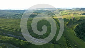 High Angle Aerial Above View of Green Meadow in the Spring, Countryside Hills