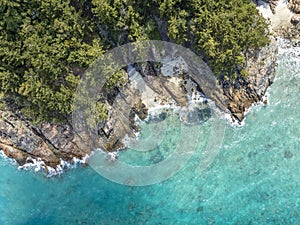 High angle aerial bird\'s eye drone view of the rocky coastline and tiny beaches on ArkhurstIsland