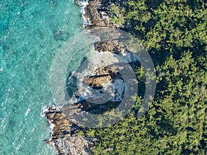 High angle aerial bird\'s eye drone view of the rocky coastline and tiny beaches on ArkhurstIsland