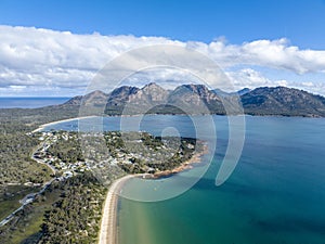 High angle aerial drone view of Coles Bay with Richardsons Beach and Hazards Mountain range