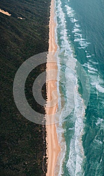 High angle aerial drone view of famous Seventy Five Mile Beach, 75 mile beach on Fraser Island, Kgari, Queensland