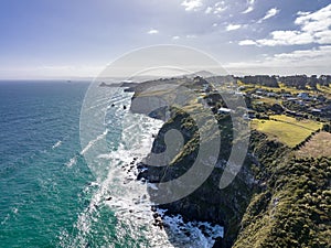 High angle aerial drone view the steep coastline at the south end of St Clair, a beachside suburb of Dunedin