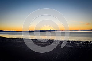 High Angle Beach at Lake With Sunset in the Background