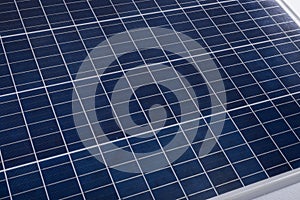 High angle close-up of blue solar panel with white grid pattern, copy space