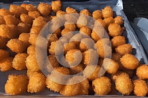 High-angle close-up view of Tater tots on an oven pan