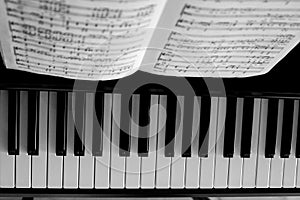 High angle closeup of a piano with a music sheet