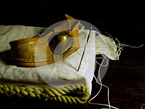 High angle closeup shot of old sailmaker`s tools on a black background