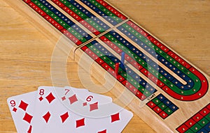 High angle closeup shot of playing cards and the board game cribbage