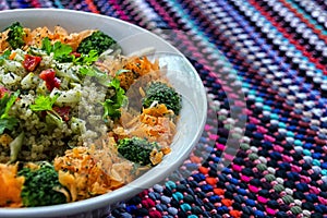 High angle closeup  shot of red bell pepper, carrot, broccoli, parsley, and quinoa salad