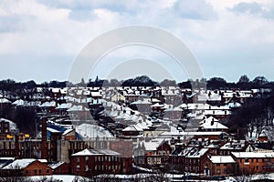 High-angle of communities in Leeds covered with snow on top of the roof on a cloudy day