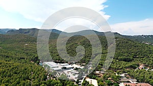 High-angle drone footage of the mountains of Castelldefels on a sunny day in Spain