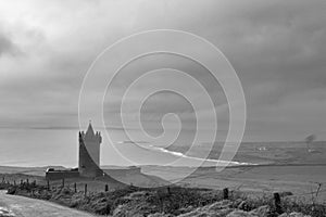 High angle greyscale shot of Doonagore Castle near Doolin in Co Clare, Ireland