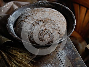 Wholegrain rye bread on rustic table in kitchen
