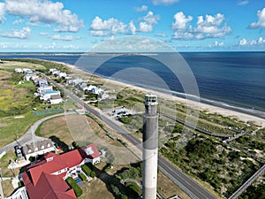 High angle of The Oak Island Lighthouse in a landscape with the blue beach in the background