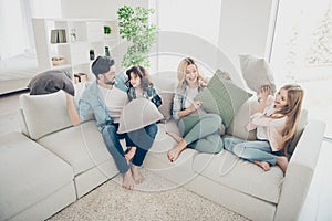 High angle photo of adopted family four members spend free time playing pillows sit couch living room