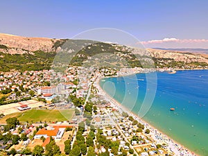 High-angle of a populated beach Croatia with trees and houses, clear and sunlit sky background