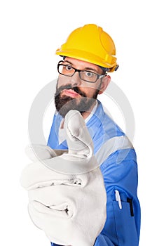 High angle portrait of serious bearded builder, foreman or repairman in the yellow helmet and glasses pointing his finger at you