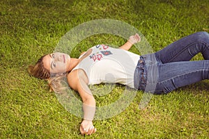 High angle portrait of smiling woman lying on grass