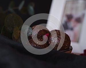 High angle selective focus shot of a bowl of delicious chocolate raspberry balls