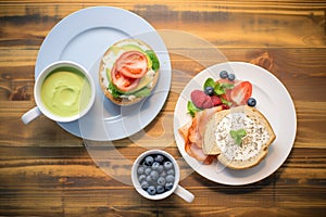 high-angle shot of a bagel breakfast with coffee and fruit