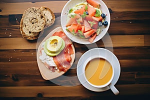 high-angle shot of a bagel breakfast with coffee and fruit