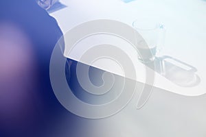 High-angle shot of a blank notepad, a pen and a cup of coffee on, light toning