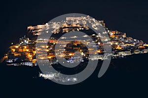 High angle shot of buildings on the hill with lit lights at nighttime