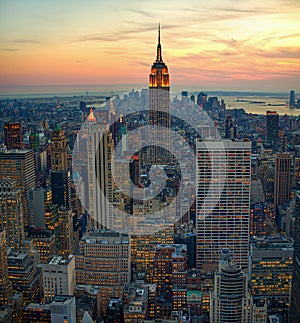 High angle shot of city buildings in new york manhattan with a sunrise in the background