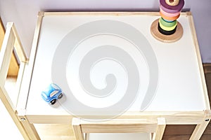 High angle shot of colorful children's toys on a light wooden table